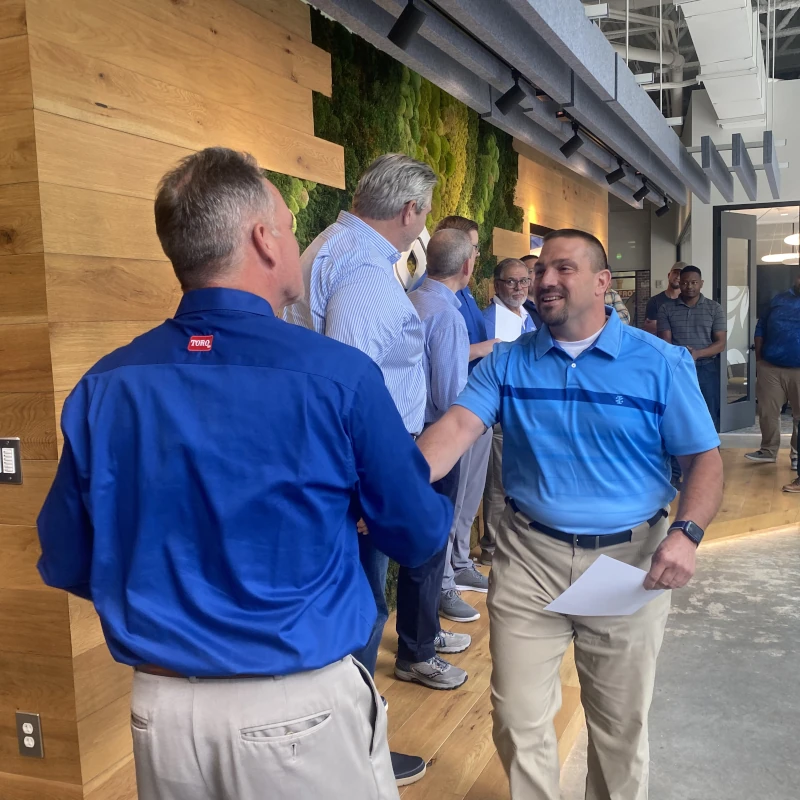 Franchise professionals meeting at an industry event.